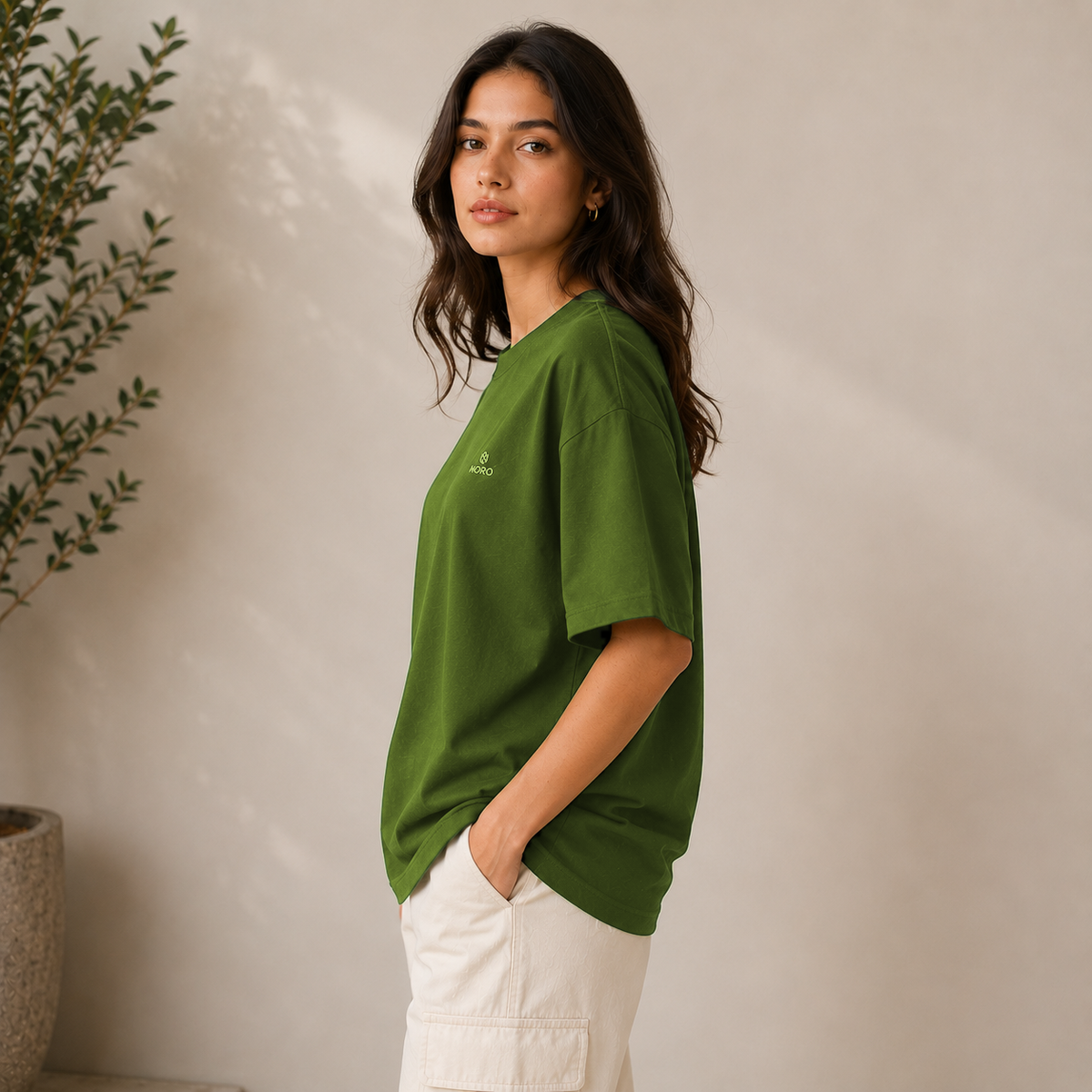 Olive green oversized t-shirt with minimal NORO logo, women's fit