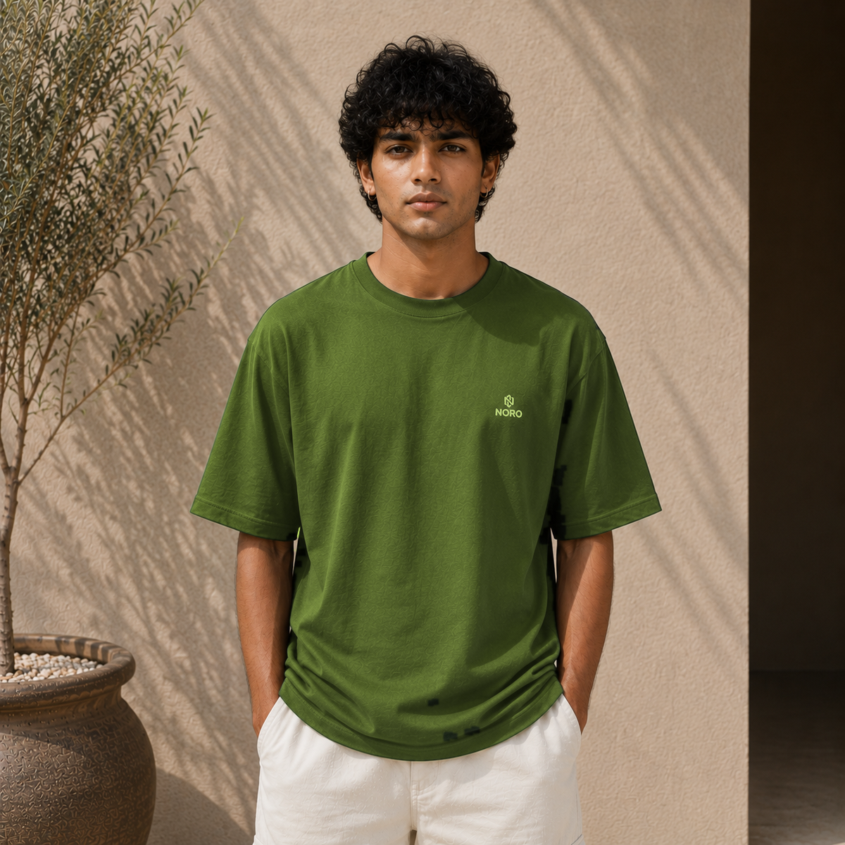 Olive green oversized t-shirt with minimal NORO logo, men's fit